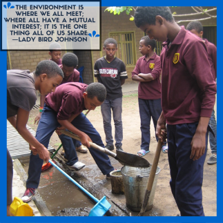 male-students-at-bci-academy-in-debre-zeyit-ethiopia-shovel-water-into-a-bucket-after-heavy-rains