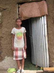 young-girl-in-ethiopia-stands-outside-her-deteriorating-home